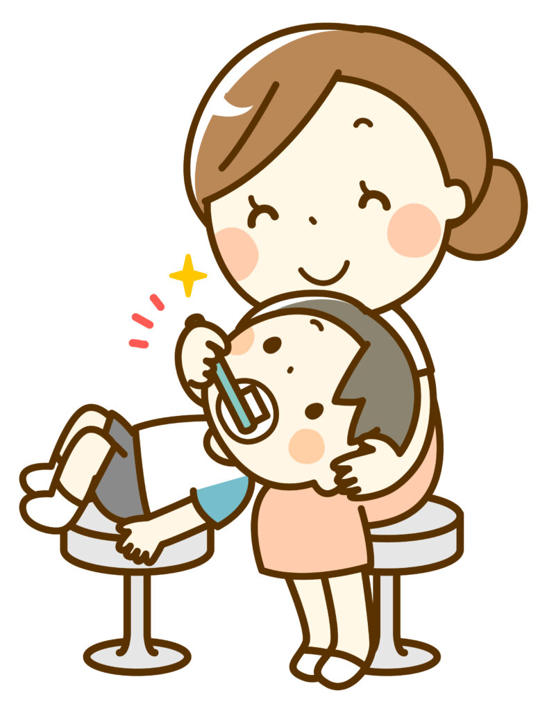 子供の歯を磨く女性